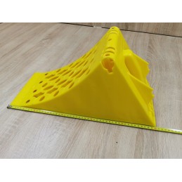 A chock under the wheel of a car trailer secures the large wheel