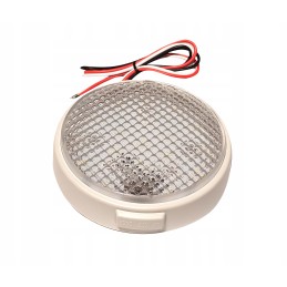 A round lamp with a switch illuminates the camper