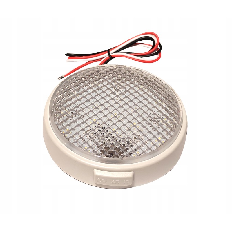 A round lamp with a switch illuminates the camper