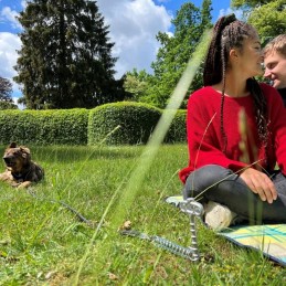 Ground anchor shock absorber for peggy peg dogs